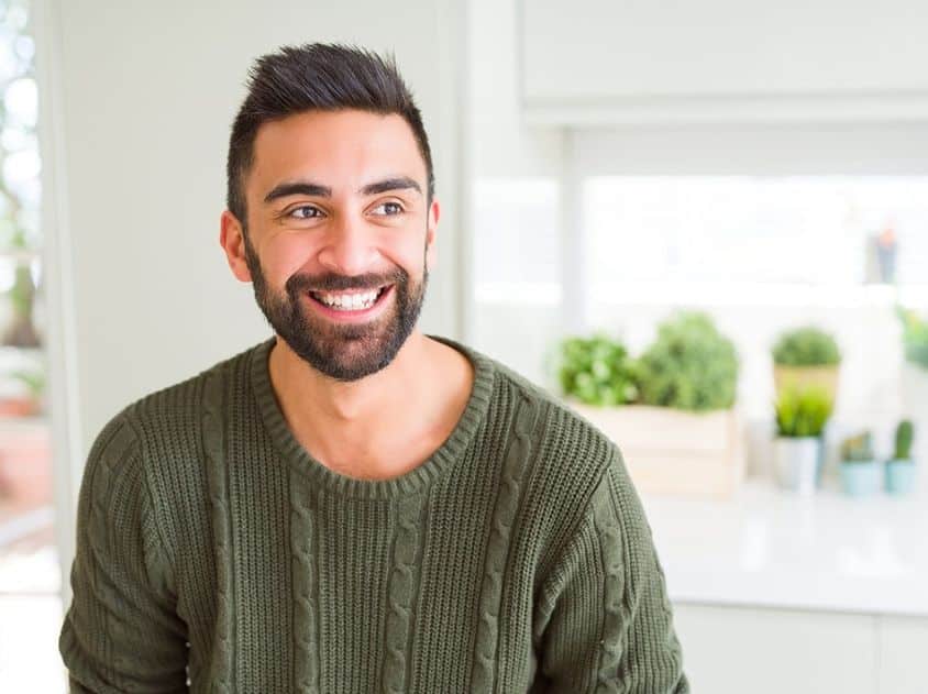 Young man in green shirt with beard smiling